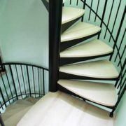 double flight light wooden steps with black steel spindles and centre column