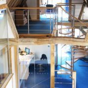 oak framed building with blue carpeted floor and oak spiral staircase