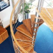 oak step spiral staircase with a blue floor