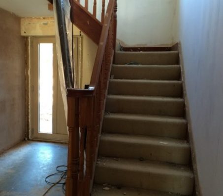 An old carpeted staircase before transformation