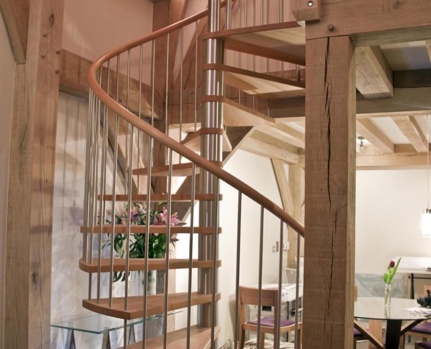 timber frame building with modern stainless steel spiral stair