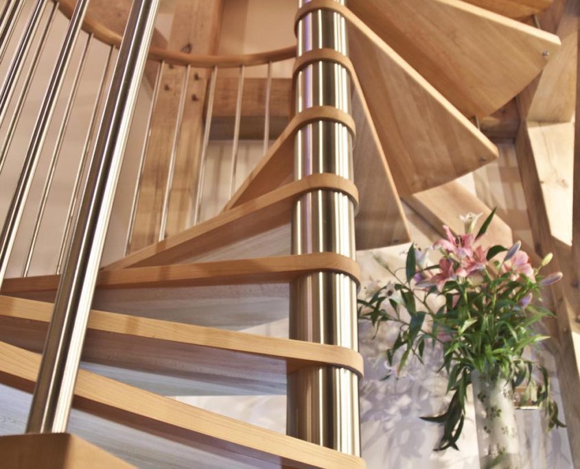 open wooden spiral stair with stainless steel spindles