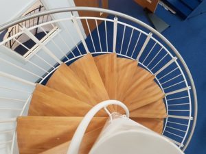 beech steps on a steel spiral stair with centre column handrail