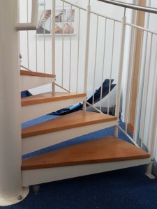 beech treads on a white steel spiral staircase