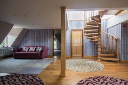 Model 71 Staircase - Tilford oak spiral staircase in a house with a purple wall