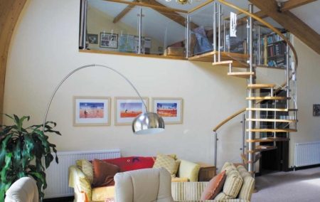 Model 76 Spiral Staircase spiral stair with curved glass balustrade rising to a mezzanine level