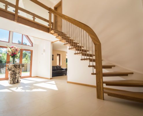 turning floating oak staircase in hallway
