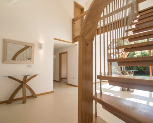 open risers of a floating oak staircase with stainless spindles