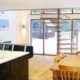 kitchen dining area with large spiral stair and large window to rear