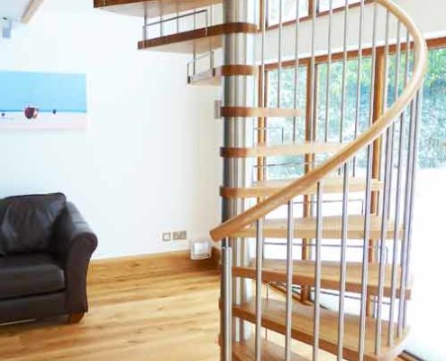 large spiral stair in a house with stainless riser bars