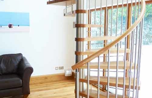 large spiral stair in a house with stainless riser bars