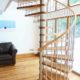 large spiral stair in a house with stainless riser bars