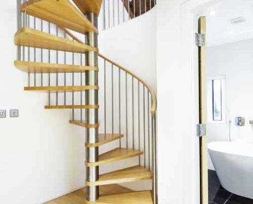 light wood floor and open riser spiral staircase with oak steps
