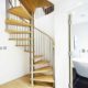 light wood floor and open riser spiral staircase with oak steps