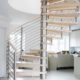 light wood spiral staircase with stainless steel balustrade