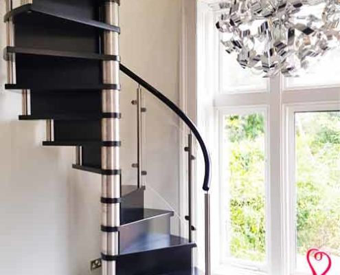 closed riser black spiral staircase with stainless steel column