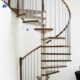 dark timber spiral staircase with stainless steel spindles