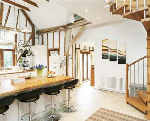 kitchen with breakfast bar with oak spiral staircase