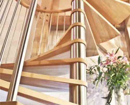 stainless steel centre column on a spiral stair with light wooden steps