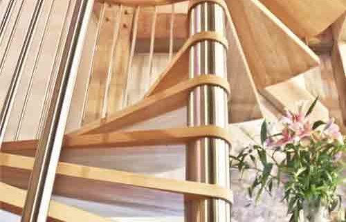 stainless steel centre column on a spiral stair with light wooden steps