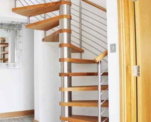 spiral staircase on grey floor with oak treads and open risers