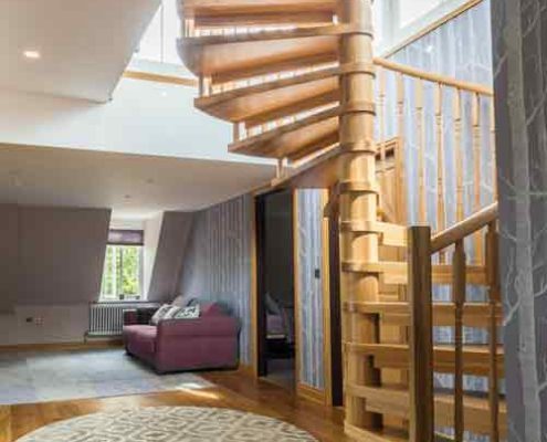 house with oak floor and oak spiral staircase rising up