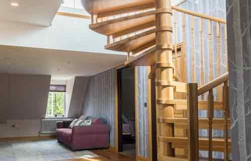 house with oak floor and oak spiral staircase rising up