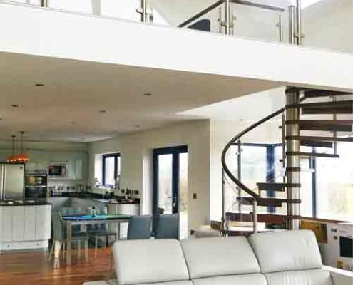 large mezzanine above a living space with modern spiral stair