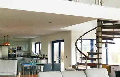 large mezzanine above a living space with modern spiral stair