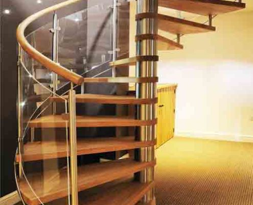 oak step spiral staircase with curved glass panels in a living area