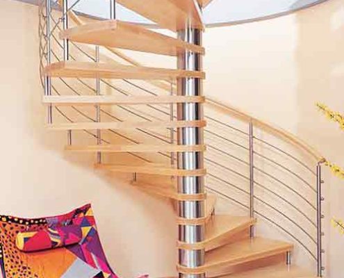 large light wood spiral staircase in a house with stainless steel horizontal bars