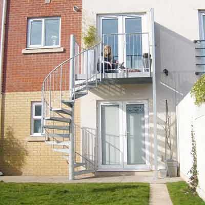 Balcony-4 lady on an outside balcony with spiral staircase