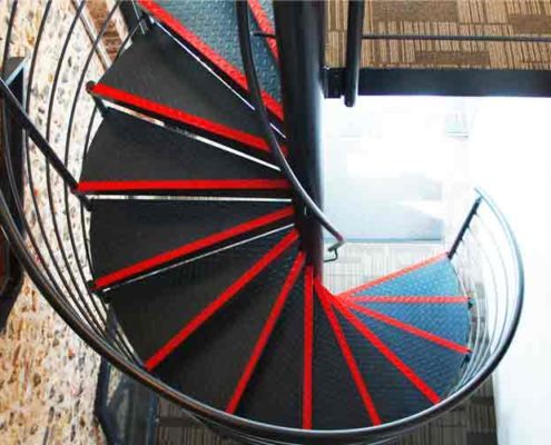 black steel spiral stair with red painted nosing