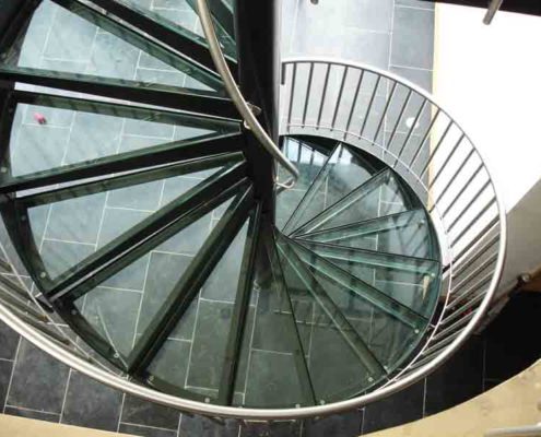glass steps on a black spiral stair viewed from above