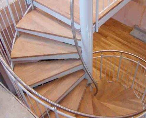 a steel and wooden spiral stair with timber flooring