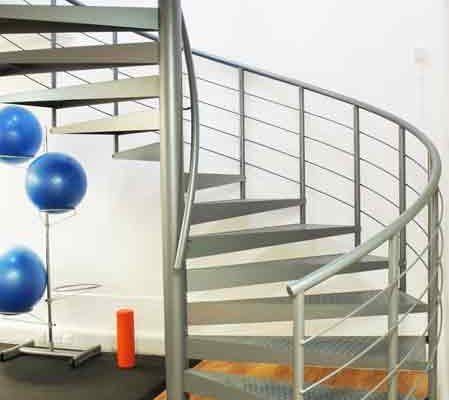 grey steel spiral staircase and timber floor