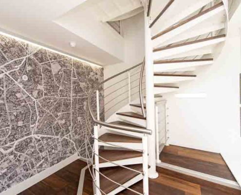 spiral stair in an estate agents in white and walnut