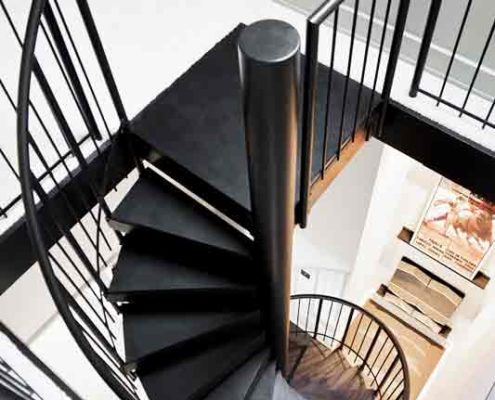 black spiral stair leading to a loft