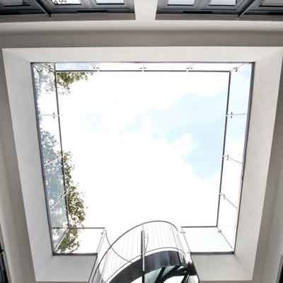 looking up at an external stairwell with glass balsutrade
