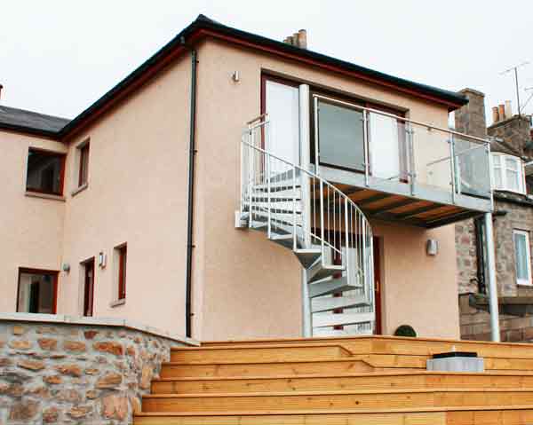 galvanised spiral stair and balcony to rear of house