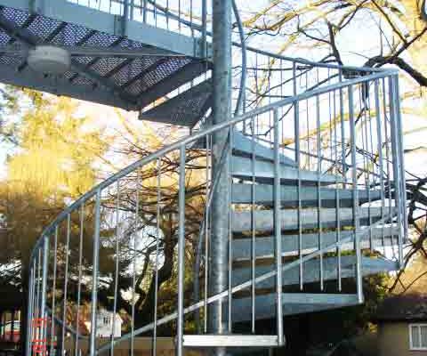 galvanised spiral fire escape with trees behind