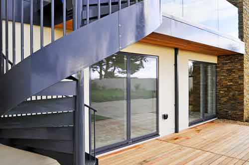 close up of external stringer of outdoor metal spiral staircase