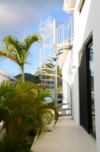 sky and sea to rear of an outdoor spiral staircase