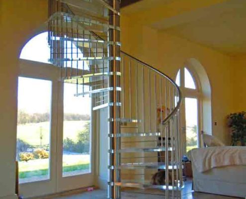 large stainless steel spiral stair with acrylic steps