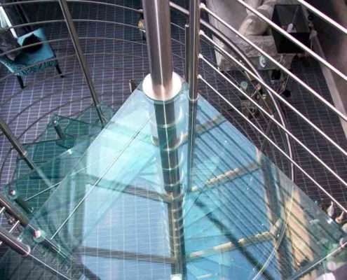 triangular top platform in glass with spiral stair below