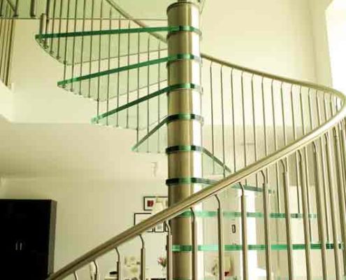 stainless steel spindles and handrail on spiral stair with glass steps