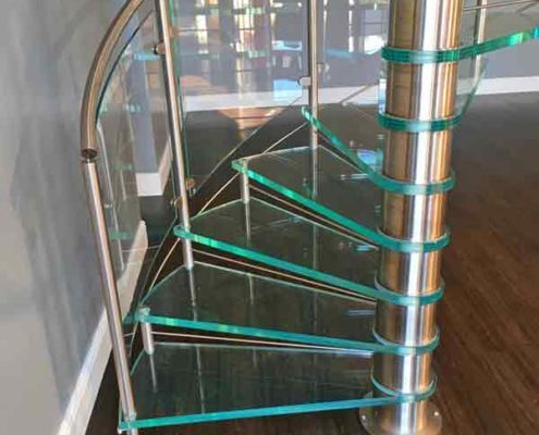 bottom section of a spiral stair with green glass steps