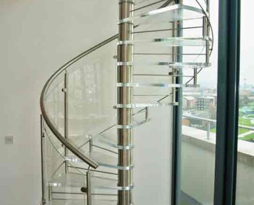 spiral stair with acrylic steps and stainless handrail
