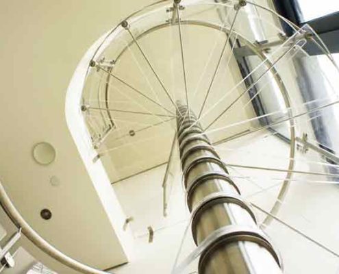 looking up through some acrylic steps on a spiral stair