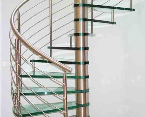 glass spiral stair set in curved wall